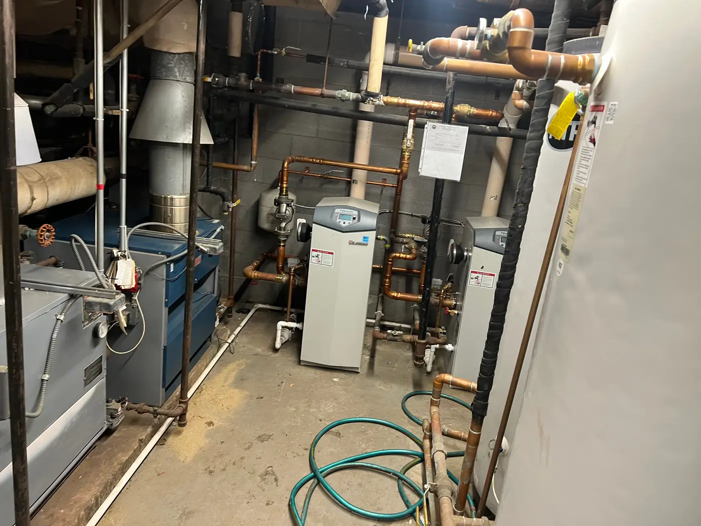 Commercial boiler room with boilers, water heaters and copper piping